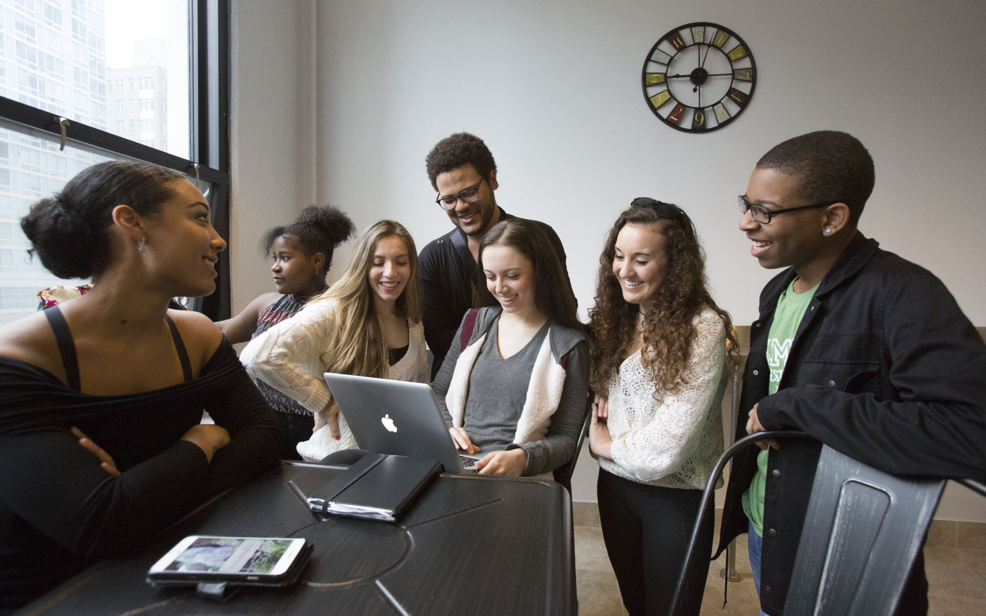 Students looking at a computer together